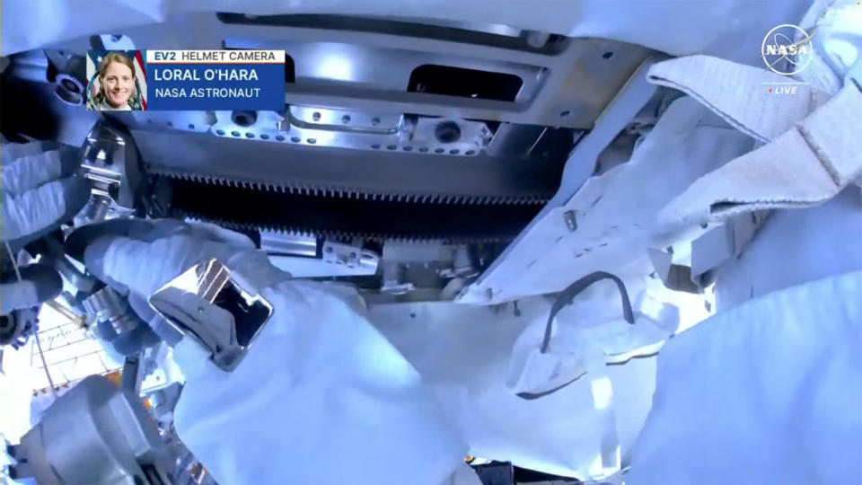 A helmet camera on O'Hara's spacesuit shows the solar array rotation mechanism and the toothed 