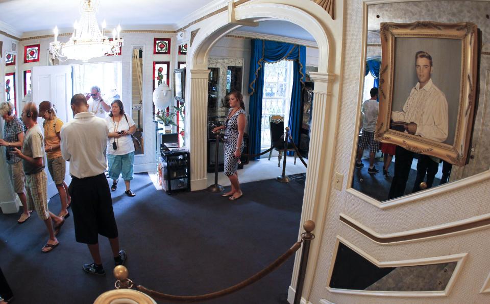 FILE -- This Aug. 2010 photo shows tourists arriving through the front door of Graceland, Elvis Presley's home in Memphis, Tenn. Graceland opened for tours on June 7, 1982. They sold out all 3,024 tickets on the first day and didn't look back, forever changing the Memphis tourist landscape while keeping Elvis and his legend alive.(AP Photo/Mark Humphrey)