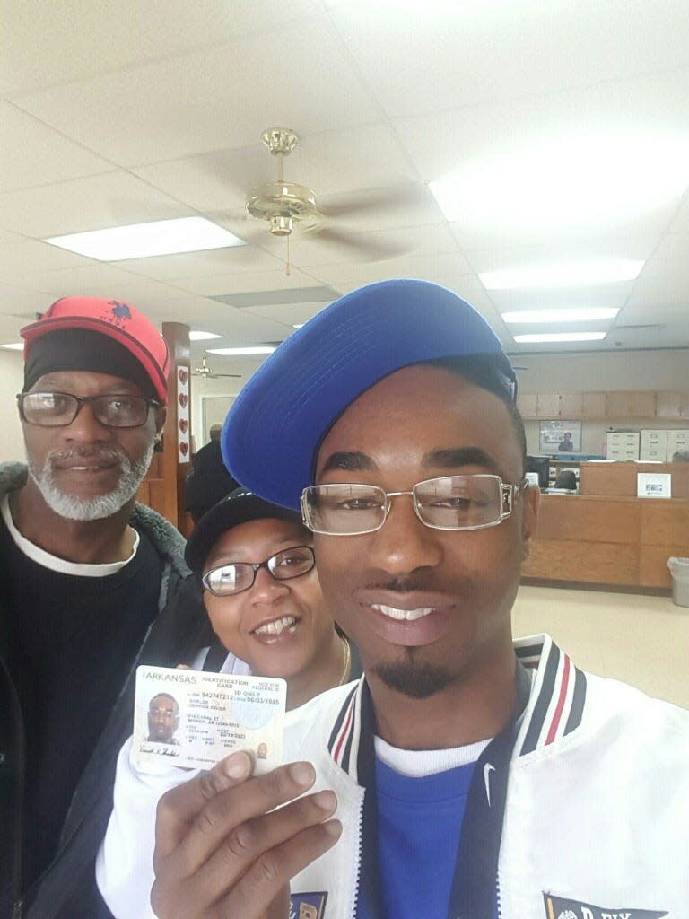 Derrick Shields, front, getting his driver's license after being released from prison.