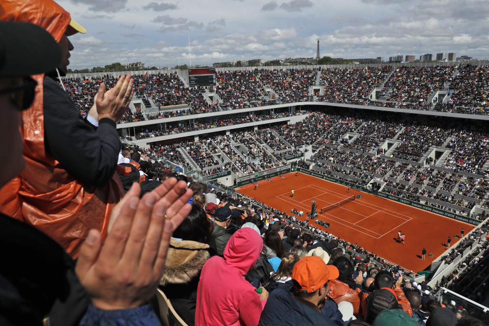 Spectators applaud Spain's Rafael Nadal and Switzerland's Roger Federer during their semifinal match of the French Open tennis tournament on center court at the Roland Garros stadium in Paris, Friday, June 7, 2019. (AP Photo/Pavel Golovkin)