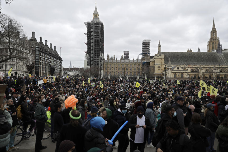 Demonstrators holding posters and flags gather at Parliament Square during a 'Kill the Bill' protest in London, Saturday, April 3, 2021. The demonstration is against the contentious Police, Crime, Sentencing and Courts Bill, which is currently going through Parliament and would give police stronger powers to restrict protests. (AP Photo/Matt Dunham)
