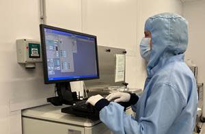 Archer staff in a research and prototyping semiconductor foundry in Sydney, Australia,  operating some of the instruments used to encapsulate the qubit material.