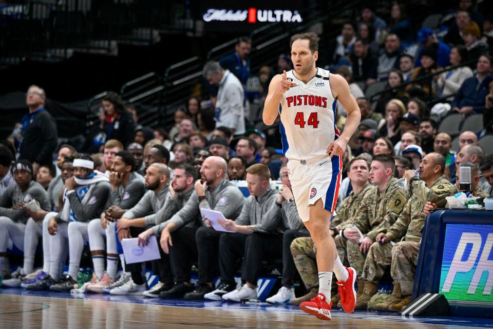 Pistons forward Bojan Bogdanovic points to his teammates after he makes a 3-point shot during the second quarter on Monday, Jan. 30, 2023, in Dallas.