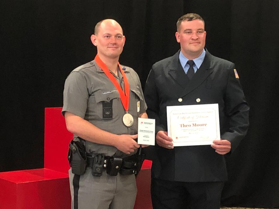 New York State Trooper Michael Crissy, left, received the American Red Cross Southern Tier Chapter "Real Heroes" Law Enforcement Award on May 25, 2023 inside Binghamton's DoubleTree by Hilton hotel. Witness and W.B. Strong Fire Company of Freeville firefighter Theo Moore, right, received a Certificate of Heroism for his efforts.