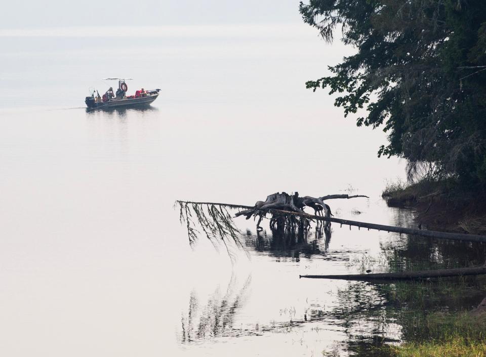 A fisherman tries his luck on a smoke shrouded Dorena Lake south east of Cottage Grove as smoke from nearby wildfires hangs in the Willamette Valley Friday, July 18, 2024.