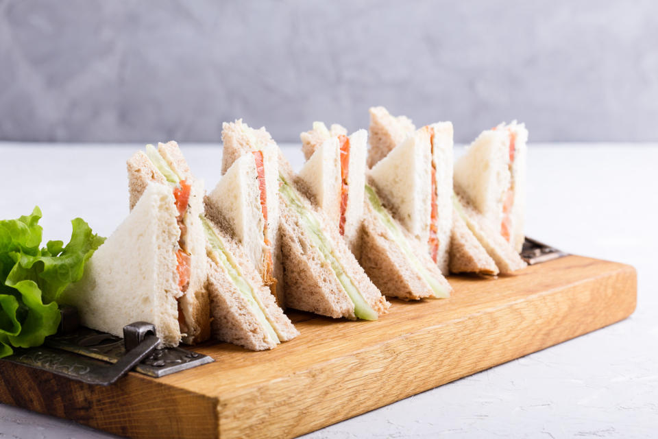 a plate of finger sandwiches