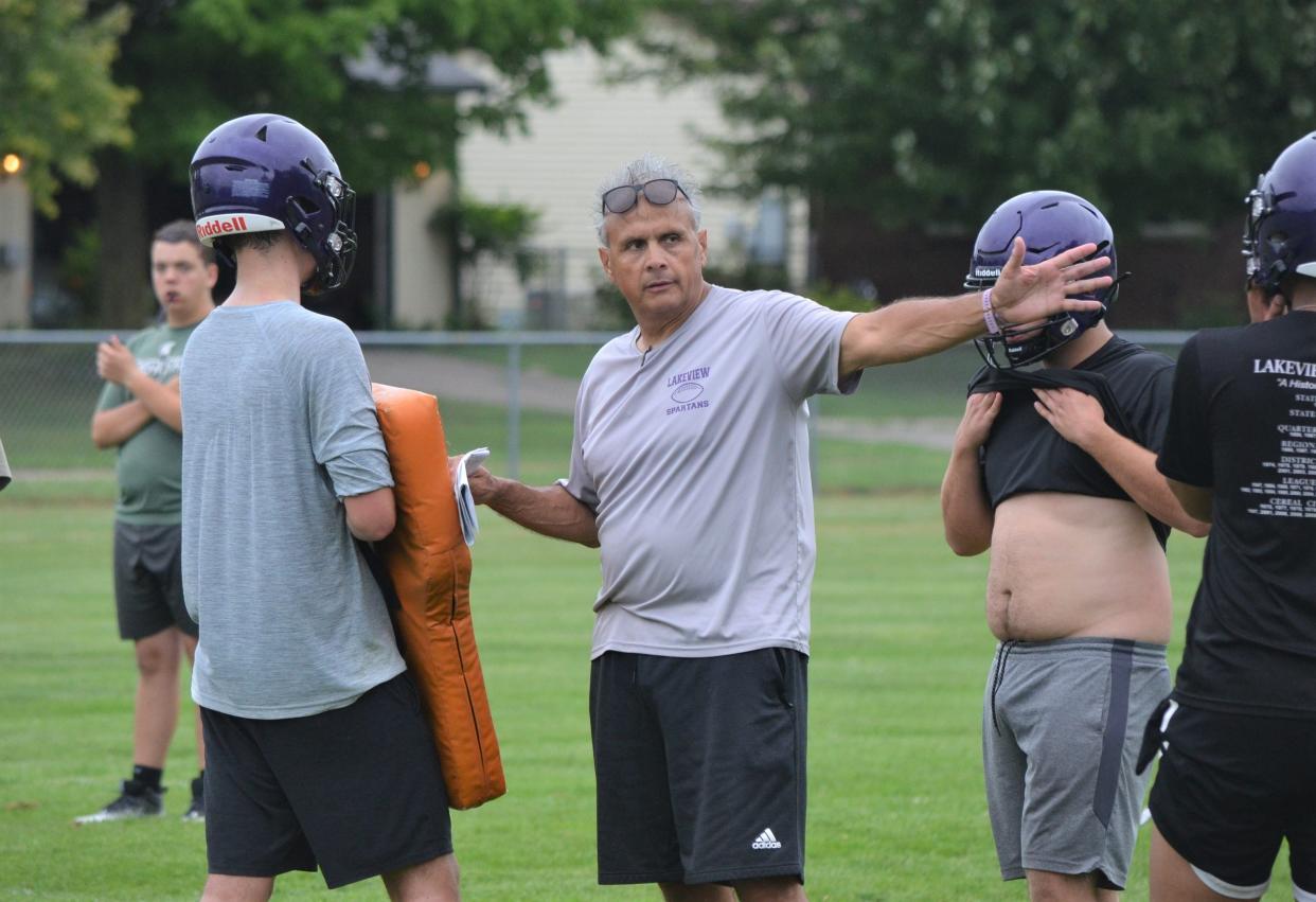 Lakeview varsity head football coach Jerry Diorio explains a technique during a drill at a preseason practice on Tuesday. The high school football season begins the week of Aug. 25.