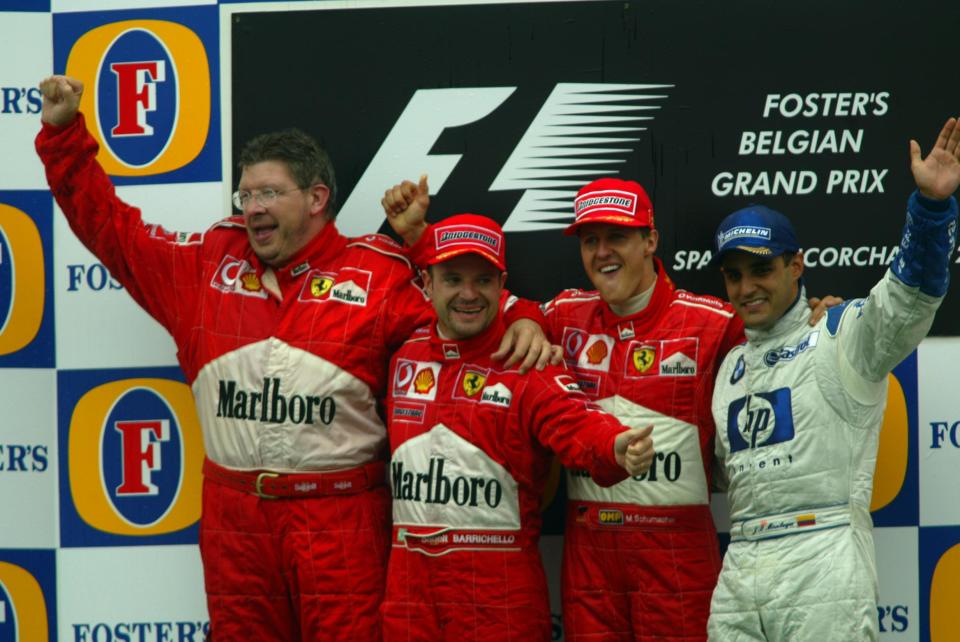 Ferrari's Michael Schumacher, Rubens Barrichello and Technical Director Ross Brawn stand with 3rd placed driver Juan Pablo Montoya and celebrate at the top of the podium after another 1-2 finish