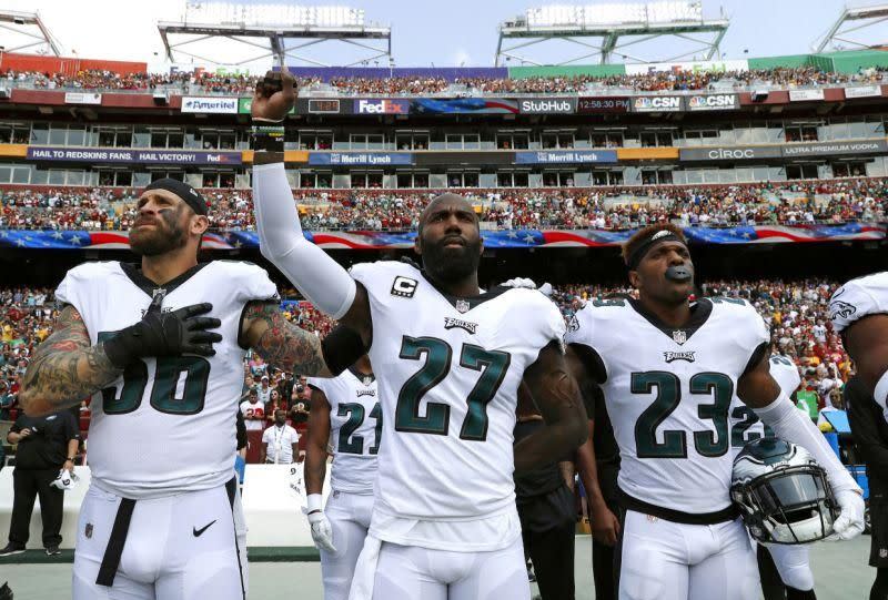 Standing between teammates Chris Long and Rodney McLeod, Eagles safety Malcolm Jenkins raised his fist during the national anthem earlier this season. (AP)