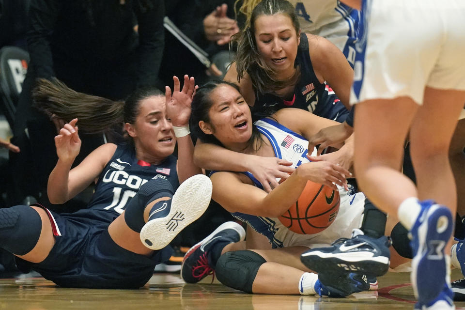 Duke guard Vanessa de Jesus, center, battles for the ball against Connecticut's Nika Muhl (10) and Caroline Ducharme, right rear, during the first half of an NCAA college basketball game in the Phil Knight Legacy tournament Friday, Nov. 25, 2022, in Portland, Ore. (AP Photo/Rick Bowmer)
