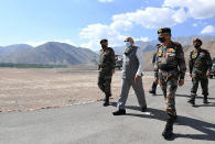 In this handout photo provided by the Press Information Bureau, Indian Prime Minister Narendra Modi walks with soldiers during a visit to the Ladakh area, India, July 3, 2020. (Press Information Bureau via AP)