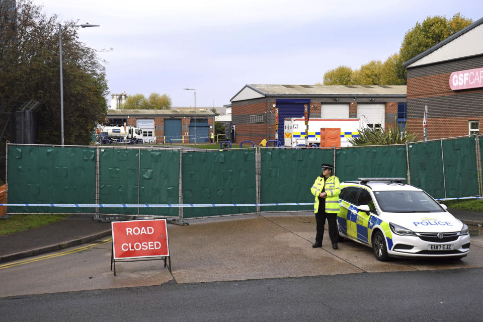 Police secure the area around the industrial estate where 39 lifeless bodies, eight women and 31 men, were discovered Wednesday in a truck, near Grays, southeast England, Friday Oct. 25, 2019. China called Friday for joint efforts to counter human smuggling after the discovery in Britain of 39 dead people believed to be Chinese who stowed away in a shipping container. (Kirsty O'Connor/PA via AP)