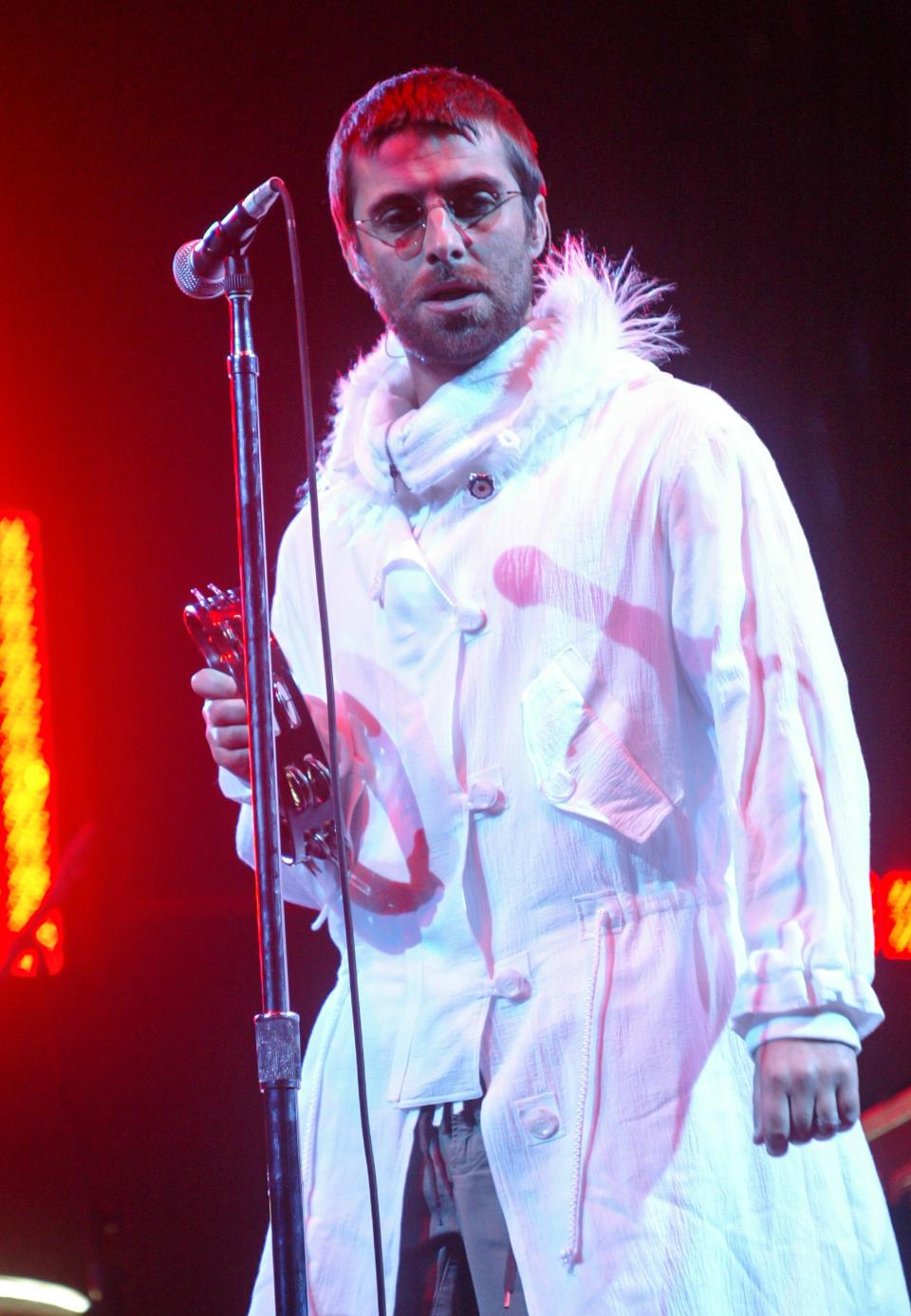 Liam Gallagher of Oasis performs on the Pyramid Stage during the 2004 Glastonbury Festival.