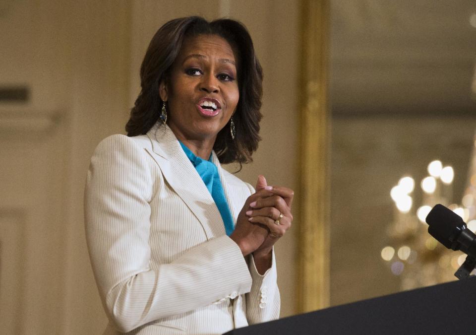 FILE - This April 11, 2104 file photo shows first lady Michelle Obama speaking in the East Room of the White House in Washington. When President Barack Obama travels abroad, getting just the leader of the free world doesn’t seem to be enough. Countries want the first lady, too. But Michelle Obama won’t join her husband when he heads to Asia next week and her absence is likely to sting, especially in Japan. It’s the first of four countries on Obama’s travel schedule and the only one welcoming him on an official state visit. (AP Photo/Jacquelyn Martin, File)