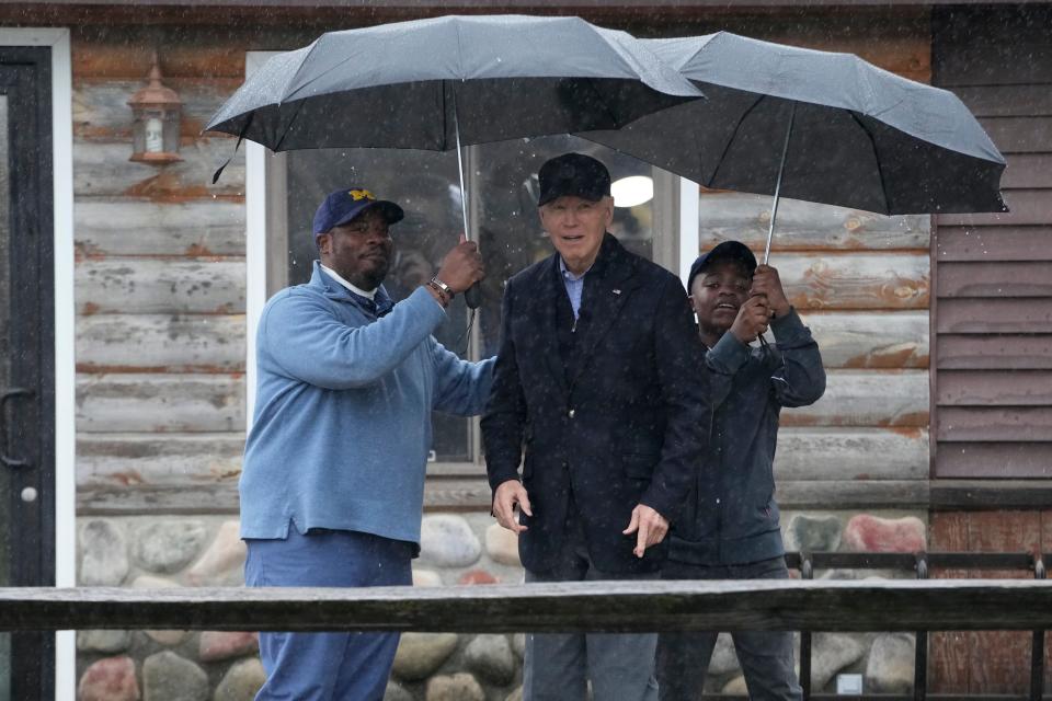 President Joe Biden poses for a photo with Hurley "HJ" Coleman IV and his father Hurley Coleman III, left, as he arrives for a campaign event at Pleasant View Golf Club in Saginaw, Mich., Thursday, March 14, 2024.