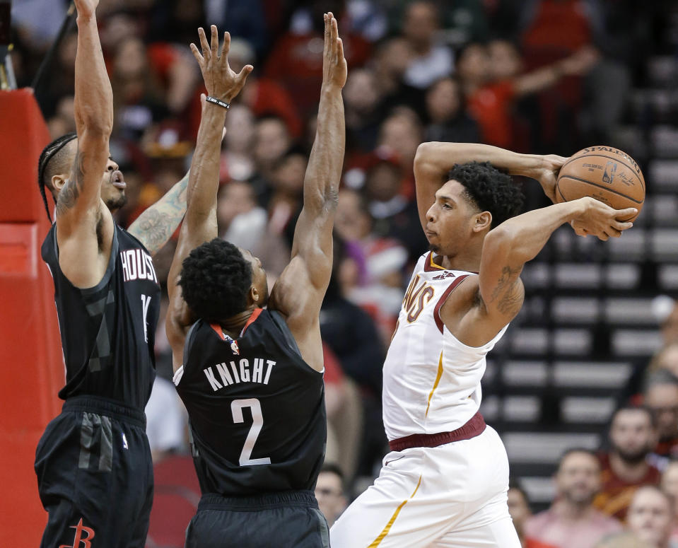 Cleveland Cavaliers guard Cameron Payne, right, passes the ball as Houston Rockets guards Brandon Knight (2) and Gerald Green defend during the first half of an NBA basketball game Friday, Jan. 11, 2019, in Houston. (AP Photo/Eric Christian Smith)