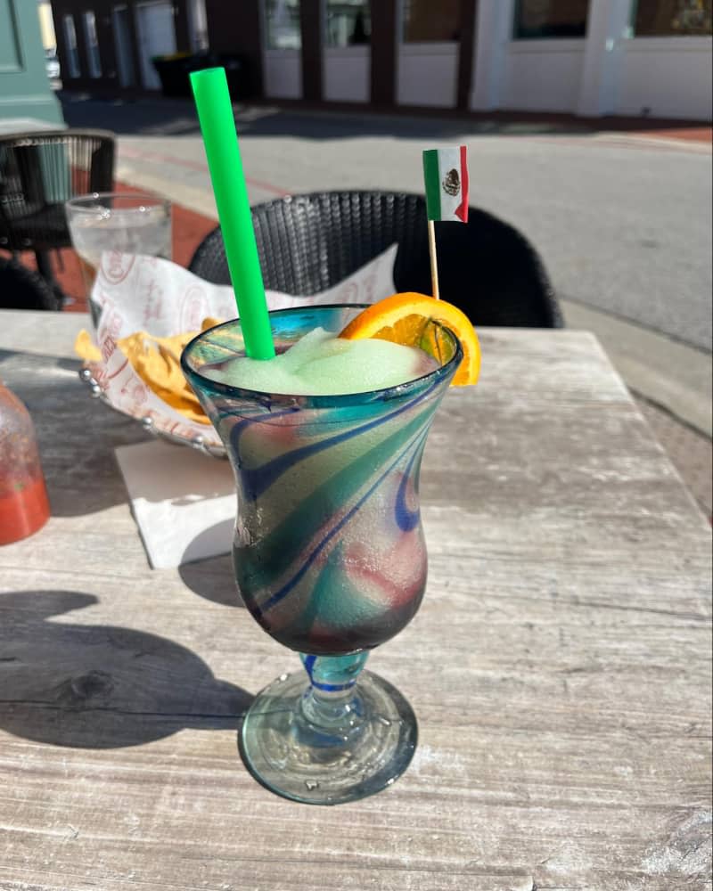 frozen swirl margarita on outdoor table at restaurant