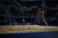 Nina Betschart, of Switzerland, serves during a women's beach volleyball match against Germany in the empty Shiokaze Park at the 2020 Summer Olympics, Saturday, July 24, 2021, in Tokyo, Japan. (AP Photo/Felipe Dana)