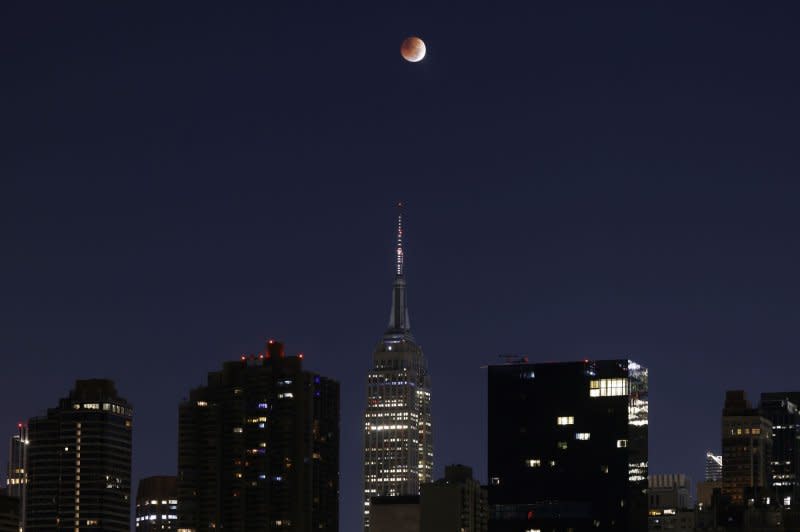 A full blood moon sets over the Empire State Building and the Manhattan skyline minutes before a total lunar eclipse in New York City in November 2022. File Photo by John Angelillo/UPI