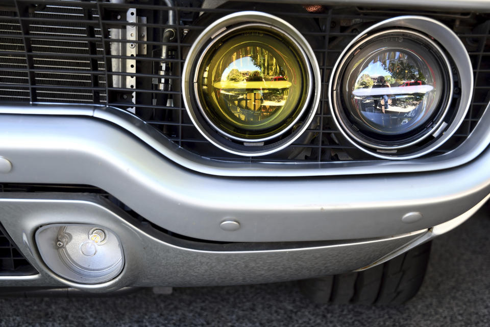 Modern headlights on Kevin Erickson's electrified 1972 Plymouth Satellite are pictured at his Commerce City, Colo., home on Sept. 20, 2022. Erickson is part of a small but expanding group of tinkerers, racers, engineers, and entrepreneurs across the country converting vintage cars and trucks into greener, and oftentimes much faster, electric vehicles. (AP Photo/Thomas Peipert)