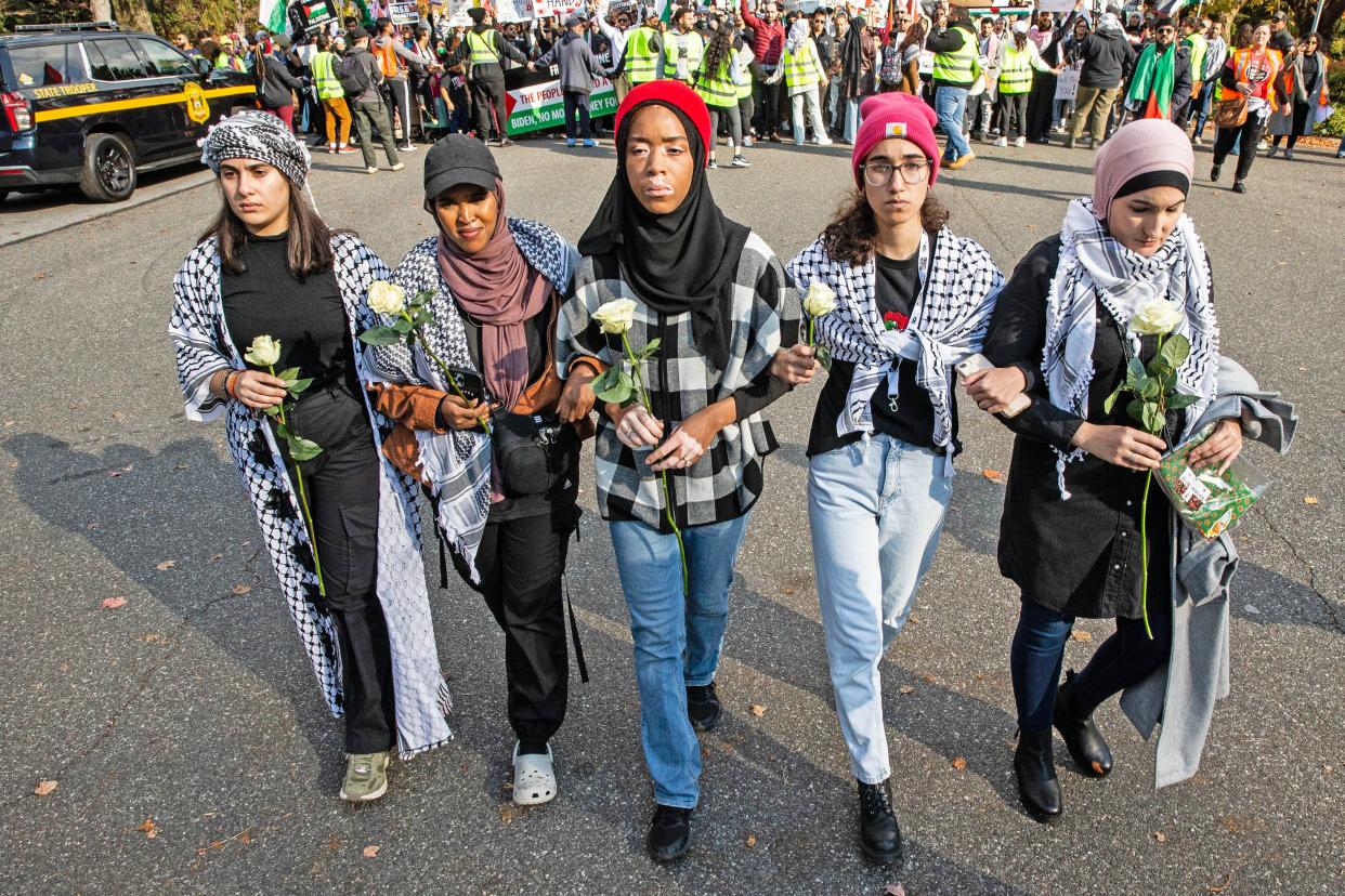 From left, Lead Rally Organizer Yara Awad, Ohio State Rep Munira Abdullahi, Delaware State Rep Madinah Wilson-Anton, Lead Organizer Dounya Ramadan and Palestinian Political Activist Linda Sarsour join arms and walk over to the secret service and police barricade in front of President Biden's home to deliver a message and roses at a Rally in Support of Palestine that culminated with a march along Barley Mill Rd. to the President's home in Greenville, Saturday, Nov. 11, 2023. According to event organizers, close to 2,000 supporters participated in the rally and march.