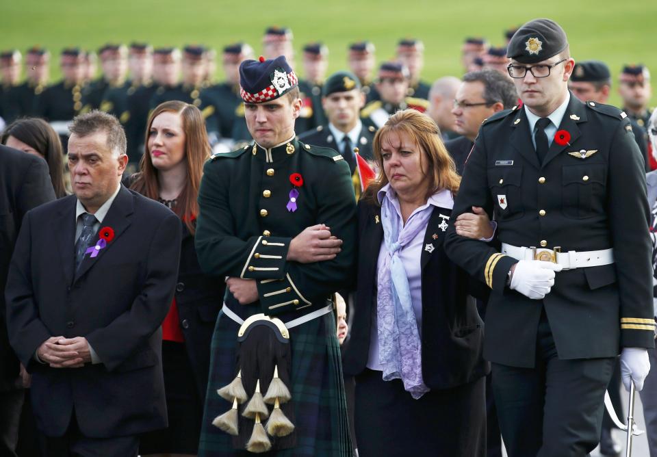 Soldiers escort Kathy Cirillo during the funeral procession for her son Cpl. Nathan Cirillo in Hamilton