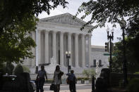 People walk past the Supreme Court on Thursday, June 27, 2024, in Washington. (AP Photo/Mark Schiefelbein)