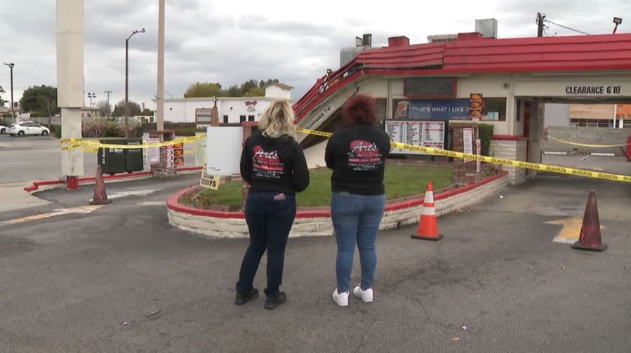 Co-owner Tammy Meier and manager Alyssa Gomez survey the damage to Art's Burgers in El Monte on April 13, 2024. (KTLA)