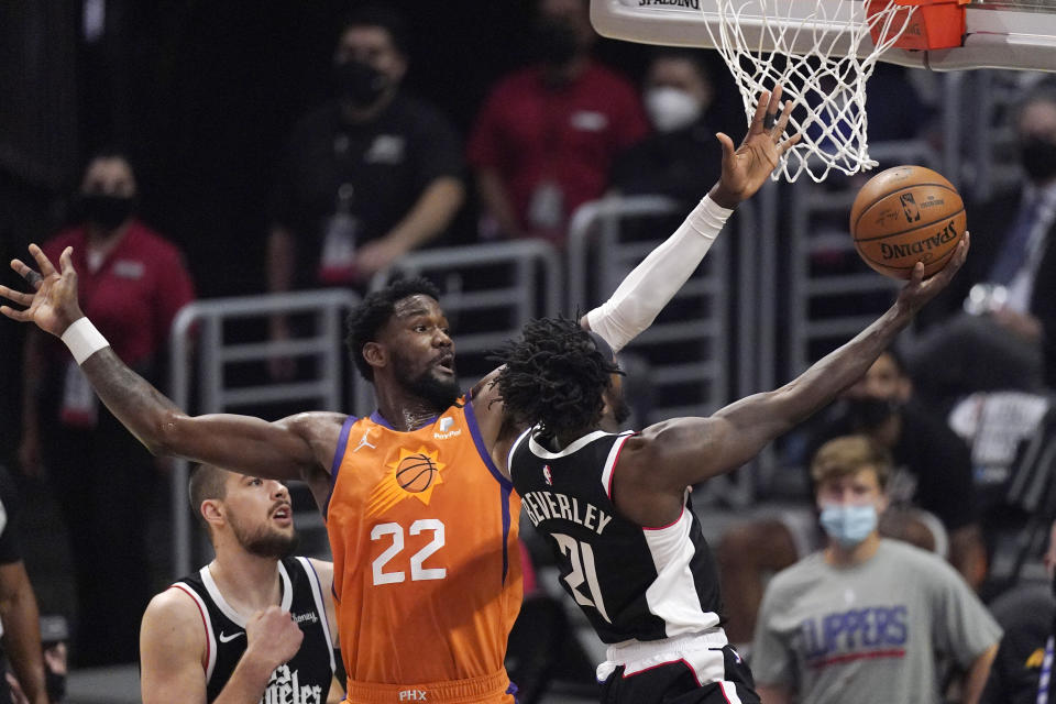 Los Angeles Clippers guard Patrick Beverley, right, shoots as Phoenix Suns center Deandre Ayton defends during the first half in Game 3 of the NBA basketball Western Conference Finals Thursday, June 24, 2021, in Los Angeles. (AP Photo/Mark J. Terrill)