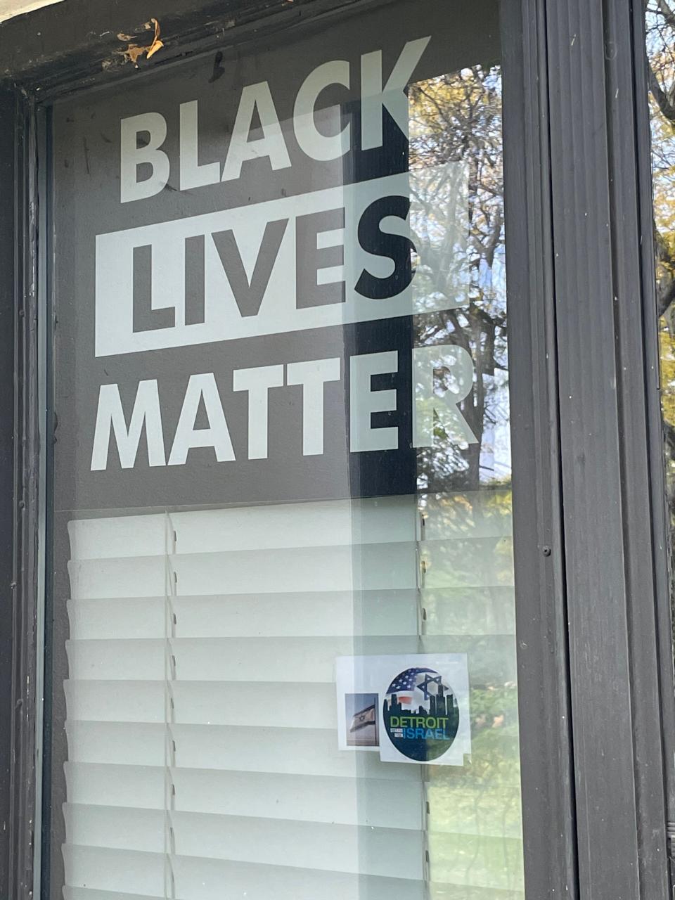 The front of Samantha Woll's home in Detroit on Oct. 26, 2023, shows a Black Lives Matter sign and underneath a decal that reads: "Detroit Stands with Israel." To the left of the decal is a photo of an Israeli flag. It's unclear when the signs were placed.