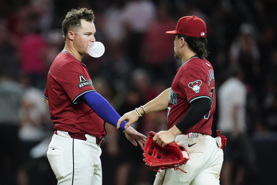Arizona Diamondbacks' Joc Pederson, left, celebrates with teammate Corbin Carroll after the final out of a baseball game against the St. Louis Cardinals, Sunday, April 14, 2024, in Phoenix. (AP Photo/Ross D. Franklin)