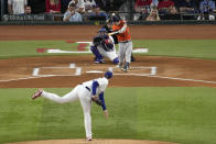 Houston Astros' Alex Bregman (2) hits a home run off Texas Rangers starting pitcher Jordan Montgomery, bottom, during the first inning in Game 5 of the baseball American League Championship Series Friday, Oct. 20, 2023, in Arlington, Texas. (AP Photo/Tony Gutierrez)