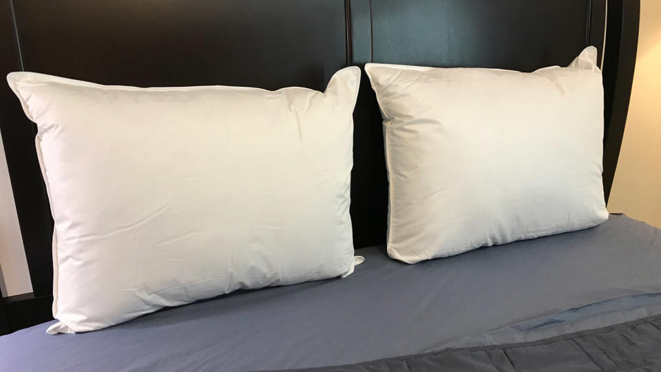 Two Parachute Down Pillows leaning against the headboard of a bed