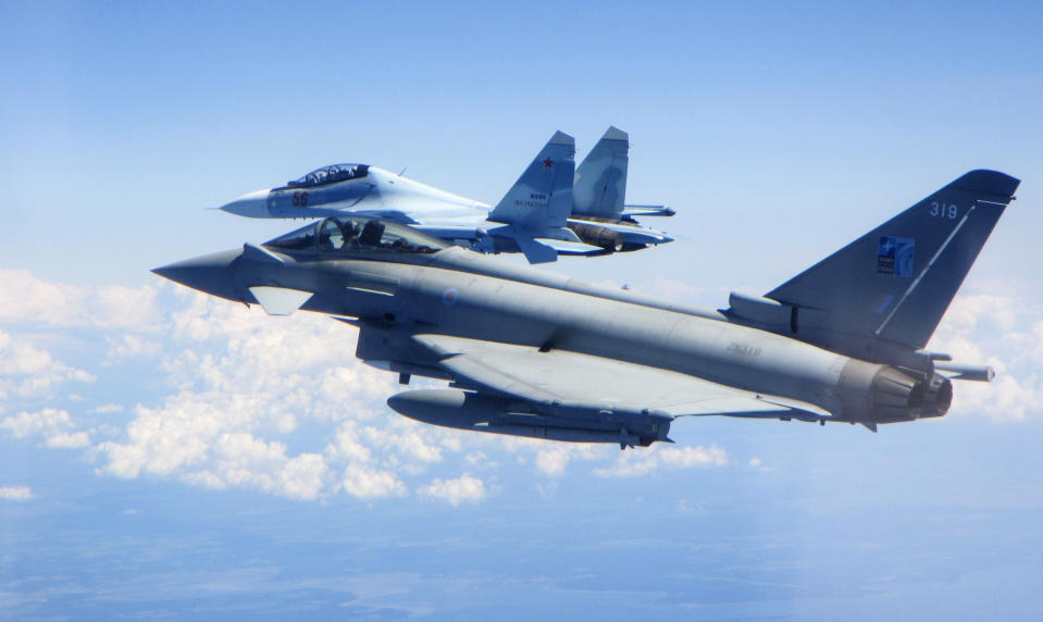 CAPTION CORRECTS AIRCRAFT NAME - In this photo taken on Saturday, June 15, 2019, a Royal Air Force Typhoon jet, foreground, flies by a Su-30 Flanker fighter. Two Royal Air Force jets deployed in Estonia have been scrambled twice in recent days, bringing the number of intercepts of Russian aircraft to eight since taking over the Baltic Air Policing mission in early May. The Typhoon jets were alerted Friday to intercept a Russian Su-30 Flanker fighter, and passed a military transport craft as it was escorting the fighter over the Baltic Sea. In a second incident on Saturday, RAF crews intercepted a Su-30 Flanker fighter and an Ilyushin Il-76 Candid transport aircraft that was traveling north from the Russian enclave of Kaliningrad toward Estonian and Finnish airspace. (UK Ministry of Defence via AP)