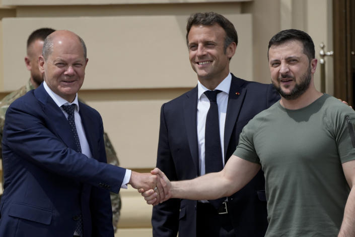 FILE - German Chancellor Olaf Scholz, left, shakes hands with Ukrainian President Volodymyr Zelenskyy, right, as French President Emmanuel Macron smiles at the Mariyinsky Palace in Kyiv, Ukraine, Thursday, June 16, 2022. At an upcoming Council of Europe summit in Iceland on May 16, 2023, France's President Emmanuel Macron and Germany's Chancellor Olaf Scholz will be joined by other leaders to discuss the current situation in Ukraine. (AP Photo/Natacha Pisarenko, File)