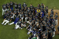 Los Angeles Dodgers pose for a group picture after defeating the Tampa Bay Rays 3-1 to win the baseball World Series in Game 6 Tuesday, Oct. 27, 2020, in Arlington, Texas. (AP Photo/David J. Phillip)