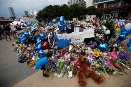 The makeshift memorial at Dallas Police Headquarters is pictured following the multiple police shootings in Dallas, Texas, U.S., July 9, 2016. REUTERS/Carlo Allegri