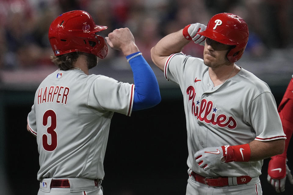 Philadelphia Phillies' Bryce Harper (3) and J.T. Realmuto, right, celebrate after Realmuto's home run in the seventh inning of a baseball game against the Cleveland Guardians, Friday, July 21, 2023, in Cleveland. (AP Photo/Sue Ogrocki)