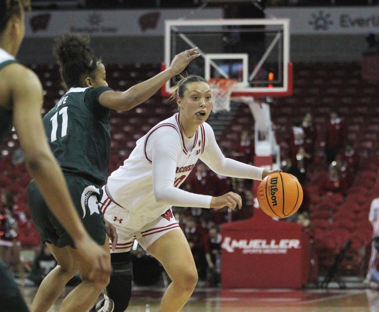 Wisconsin's Halle Douglass drives past Michigan State's Jocelyn Tate on March 3 at the Kohl Center in Madison. Douglass was sidelined for a year with an injury to her right knee. She returned to action in December, but her recovery continues.