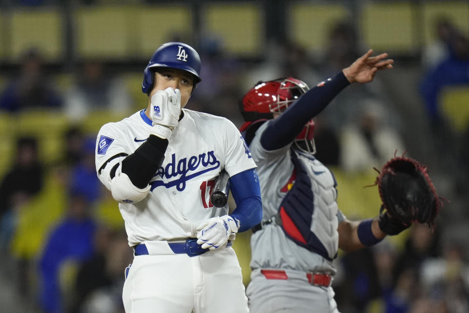 Los Angeles Dodgers' Shohei Ohtani blows into his hand after swinging at a pitch during the fifth inning of a baseball game against the St. Louis Cardinals Saturday, March 30, 2024, in Los Angeles. (AP Photo/Jae C. Hong)