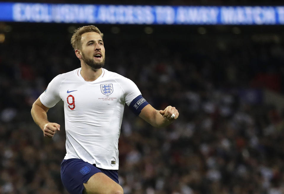 England's Harry Kane, right, celebrates scoring the fifth goal during the Euro 2020 group A qualifying soccer match between England and Montenegro at Wembley stadium in London, Thursday, Nov. 14, 2019. (AP Photo/Kirsty Wigglesworth)