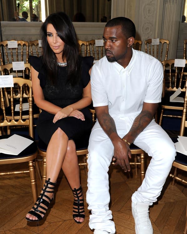 Kim Kardashian Drags Kanye West To Paris — He Looks Bored