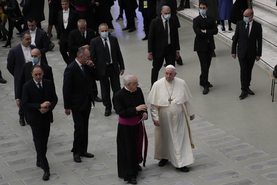 Pope Francis walks towards faithful at the end of his weekly general audience in the Paul VI Hall, at the Vatican, Wednesday, Dec. 22, 2021. (AP Photo/Alessandra Tarantino)