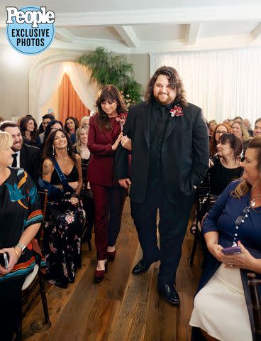 <p>Christine Skari Photography</p> Wolfgang Van Halen walks down the aisle with mom Valerie Bertinelli at his wedding to Andraia Allsop on October 15th, 2023