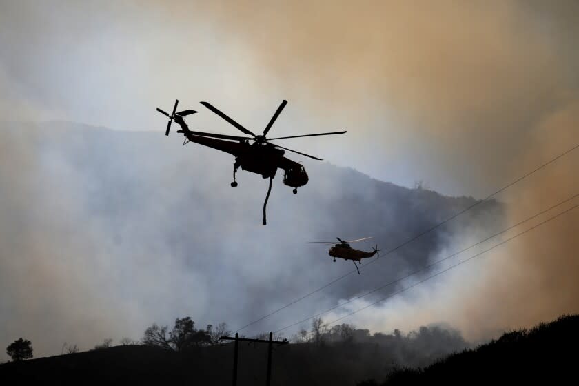 SAN GABRIEL MOUNTAINS, CA - AUGUST 29: Fire crews are working to contain a brush fire burning near Mile Marker 21 along San Gabriel Canyon Road near the San Gabriel Dam. According to the Angeles National Forest, the Gulch Fire has burned up to 100 acres (CBS Los Angeles) on Monday, Aug. 29, 2022 in San Gabriel Mountains, CA. (Gary Coronado / Los Angeles Times)