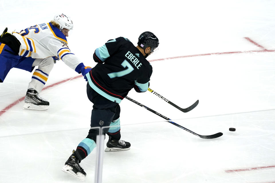 Seattle Kraken's Jordan Eberle scores his third goal of the night as Buffalo Sabres' Rasmus Dahlin defends during the third period of an NHL hockey game Thursday, Nov. 4, 2021, in Seattle. (AP Photo/Elaine Thompson)