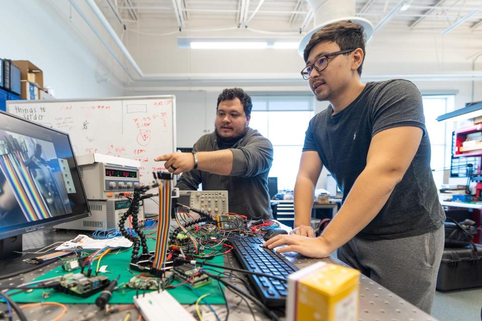 Embry-Riddle student researchers Daniel Posada and Aryslan Malik work on the EagleCam project, which began nearly five years ago. Their camera in a CubeSat made it to the Moon's surface Wednesday but hasn't produced any photos yet, as it is possibly experiencing a wifi problem.