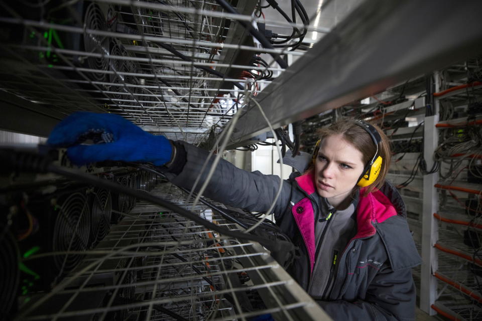 An employee works at the data centre of BitRiver company providing services for cryptocurrency mining in the city of Bratsk in Irkutsk Region, Russia March 2, 2021. BitRiver offers hosting services and turnkey solutions for cryptocurrency mining operations to institutional investors including bitcoin mining firms. Picture taken March 2, 2021. REUTERS/Maxim Shemetov