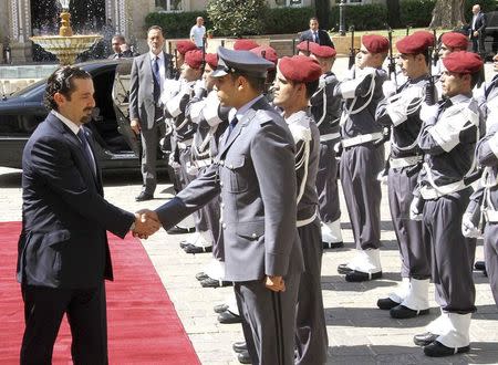 Former Lebanese Prime Minister Saad al-Hariri reviews an honour guard upon his arrival at the government's headquarters in Beirut August 8, 2014. REUTERS/Dalati Nohra/Handout via Reuters