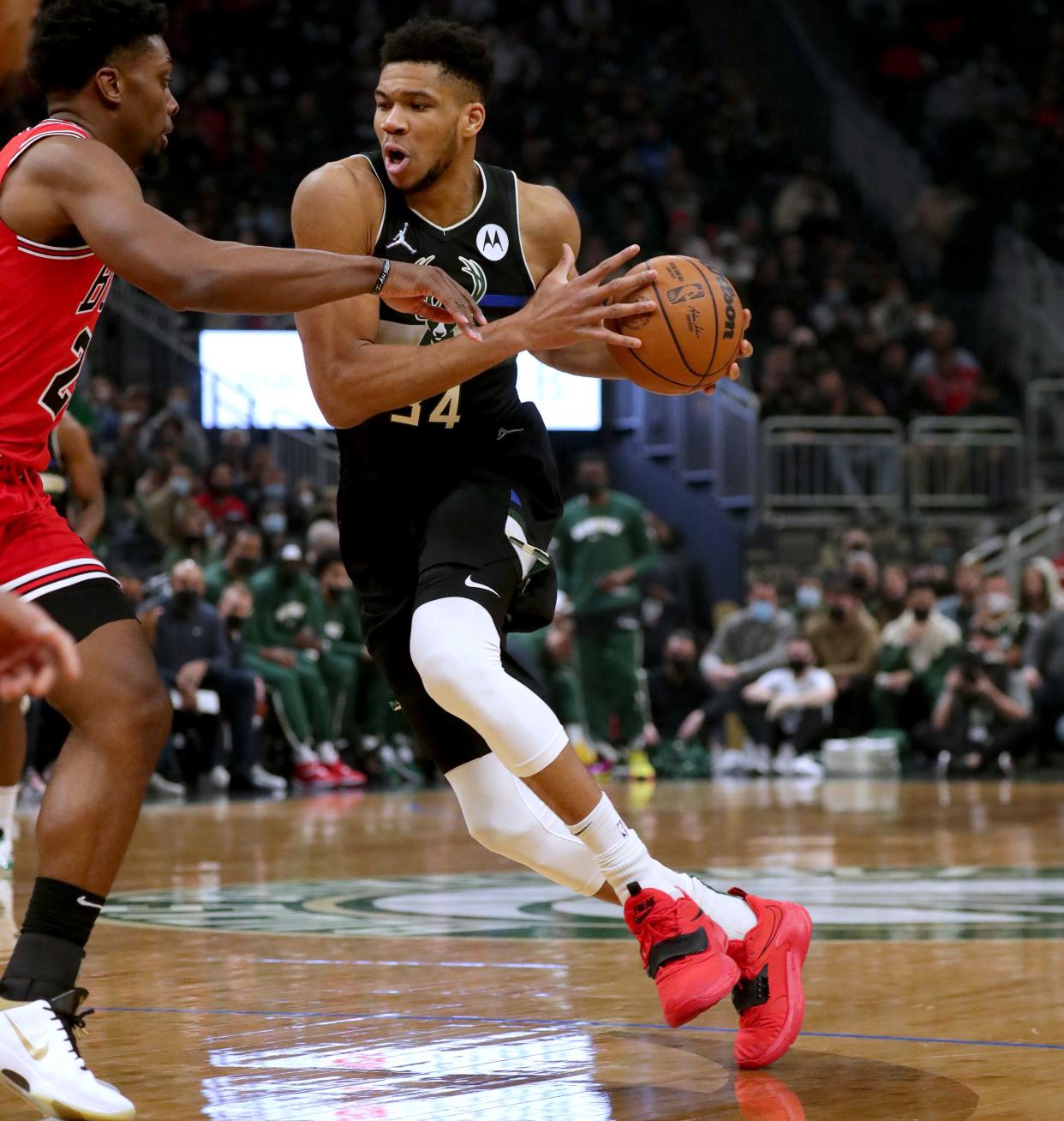 Bucks forward Giannis Antetokounmpo looks to drive to the basket against Bulls forward Tyler Cook during the first quarter Friday at Fiserv Forum in Milwaukee.